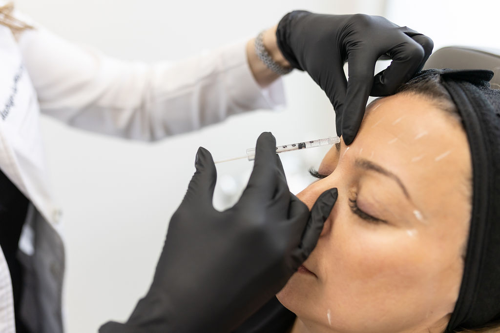 Nurse administering a Botox treatment at Distinct Medical Aesthetics in Oakville
