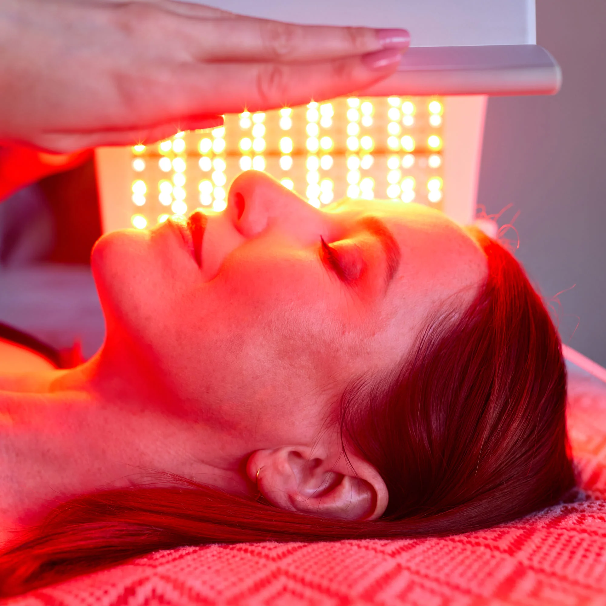 Patient resting beneath illuminated LightStim Elipsa LED panels